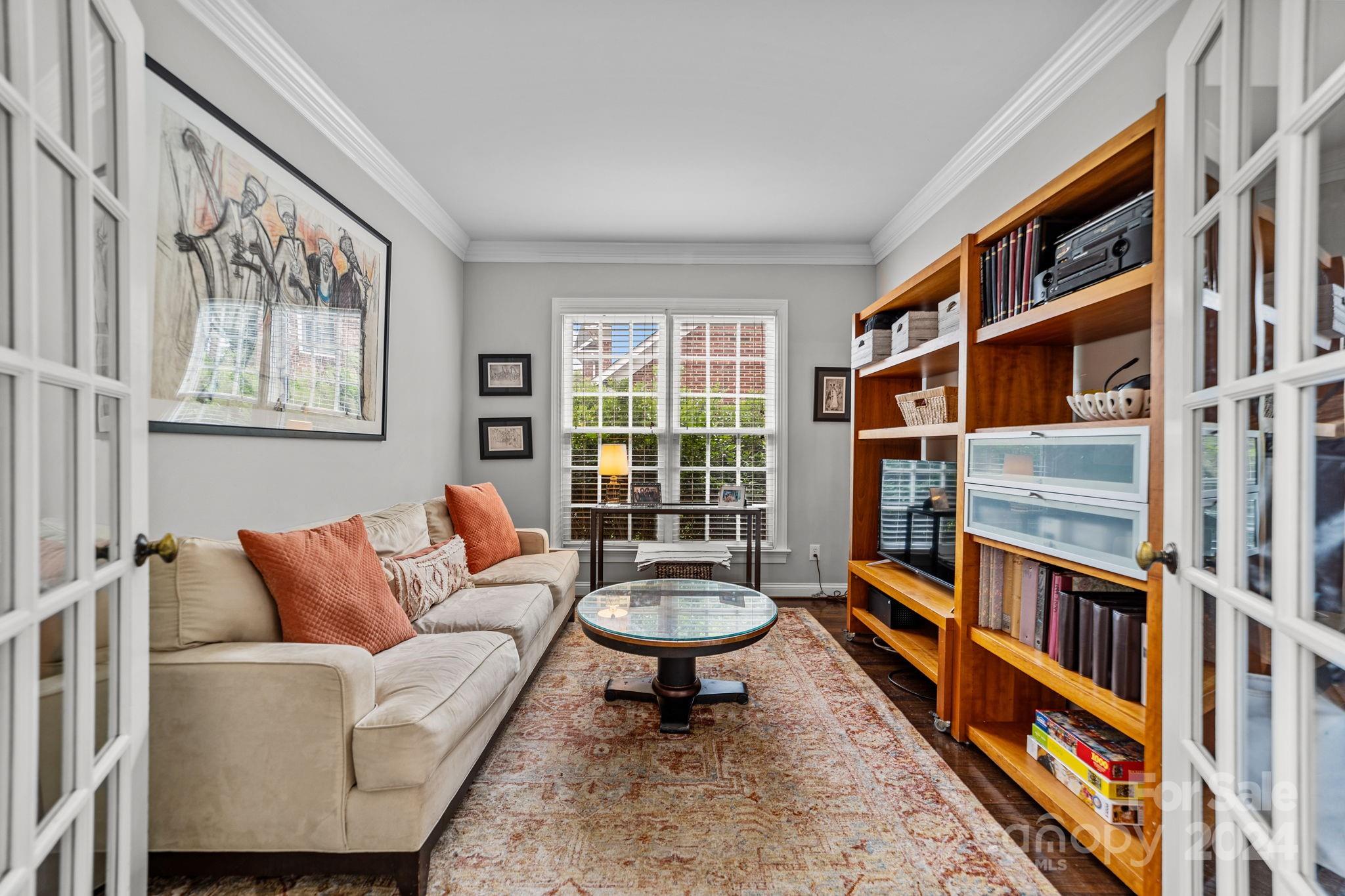 20443 Middletown Road Cornelius, NC 28031 - Photo 10 of 31 a living room with furniture a rug and a book shelf