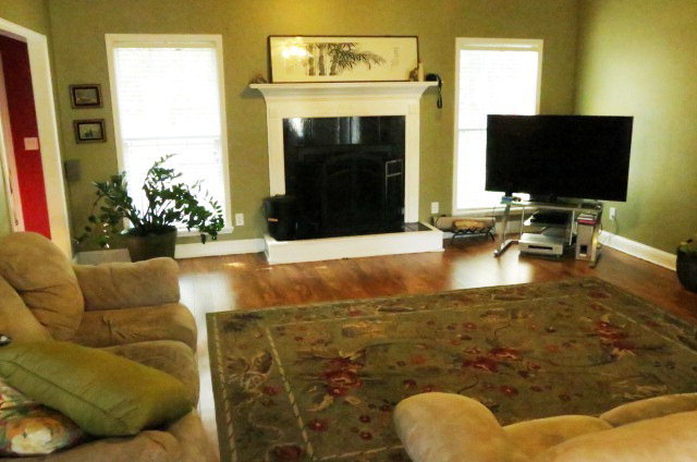 132 Deer Ridge Drive Lizella, GA 31052 - Photo 2 of 11 a living room with fireplace furniture and a flat screen tv