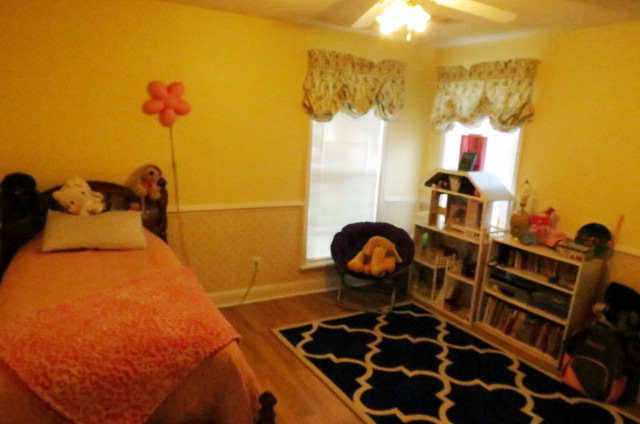 132 Deer Ridge Drive Lizella, GA 31052 - Photo 7 of 11 a bedroom with a bed and a chandelier