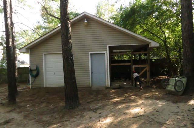 132 Deer Ridge Drive Lizella, GA 31052 - Photo 10 of 11 a view of backyard with small cabin and a chair