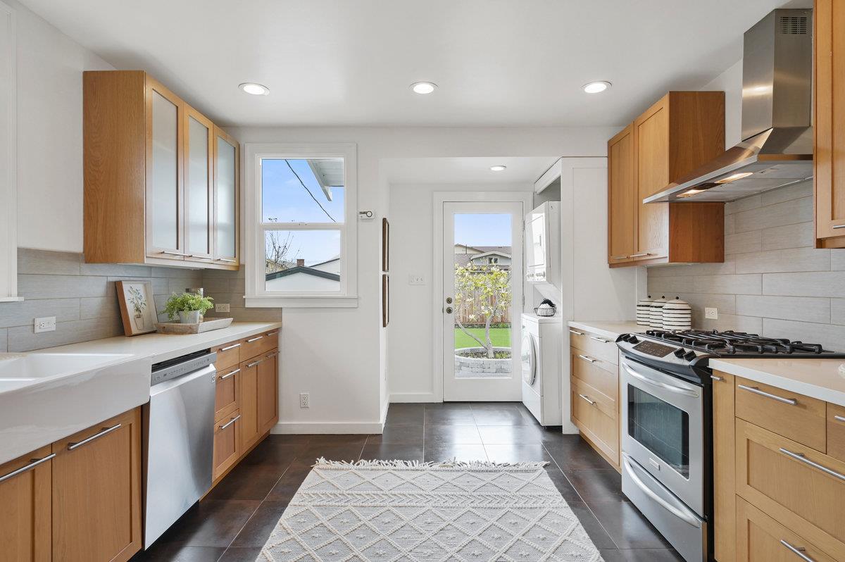 1333 67th Street Berkeley, CA 94702 - Photo 25 of 63 a kitchen with stainless steel appliances granite countertop a stove a sink and a refrigerator