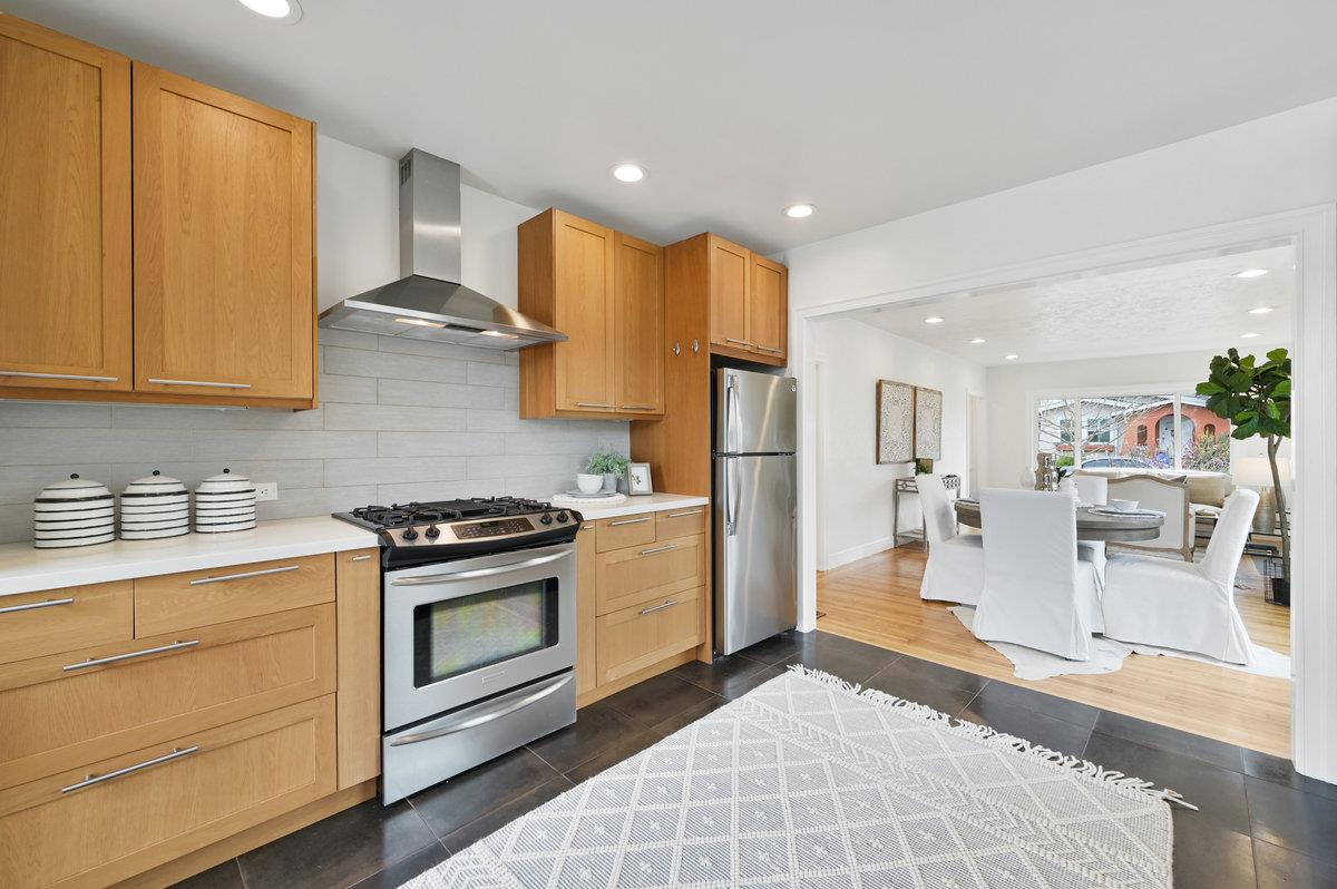 1333 67th Street Berkeley, CA 94702 - Photo 27 of 63 a kitchen with stainless steel appliances granite countertop a stove a sink and a refrigerator