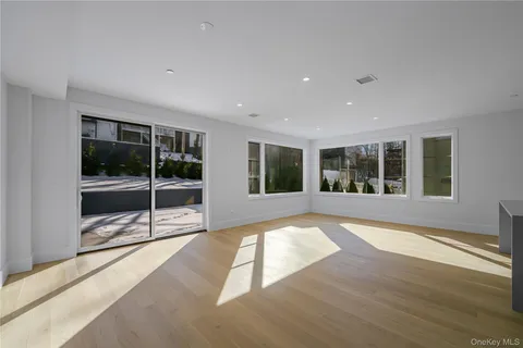 a view of an entryway with wooden floor and garden
