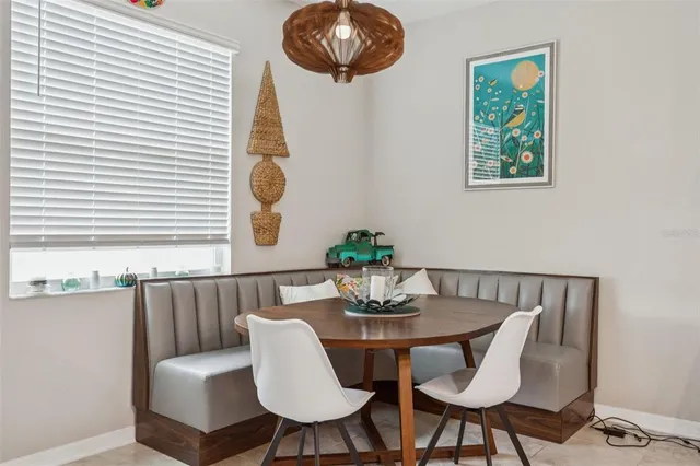 a dining room with furniture and window