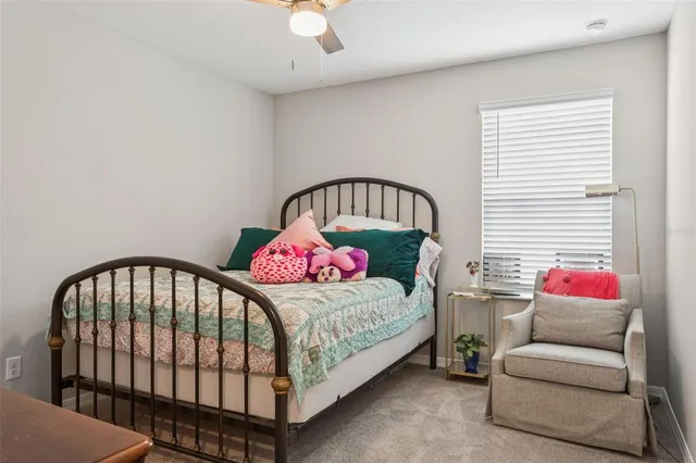 a bathroom with a granite countertop sink a toilet and a window