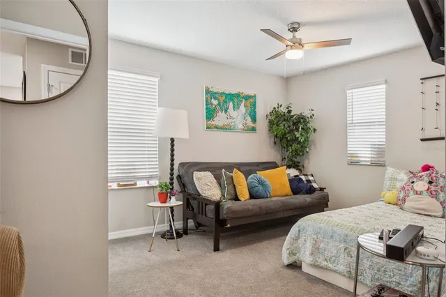 a bedroom with a bed and a book shelf