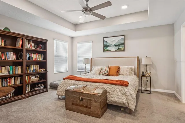 a bedroom with bed and a chandelier