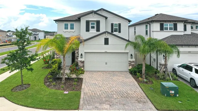 an aerial view of residential houses with outdoor space and street view