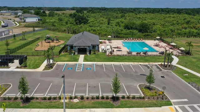 an aerial view of a house with a garden and trees