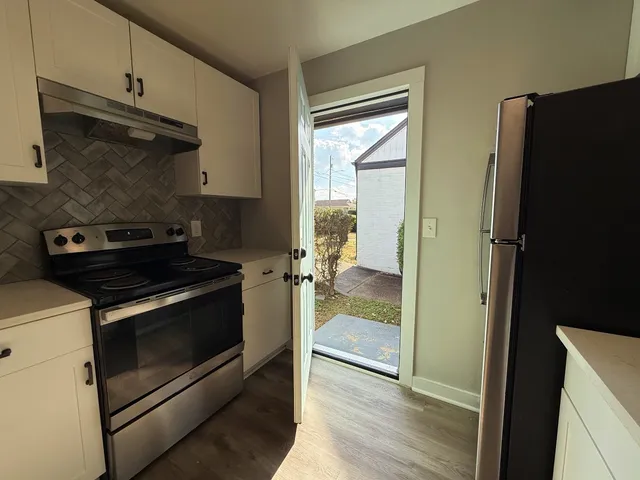 a kitchen with a stove and a refrigerator