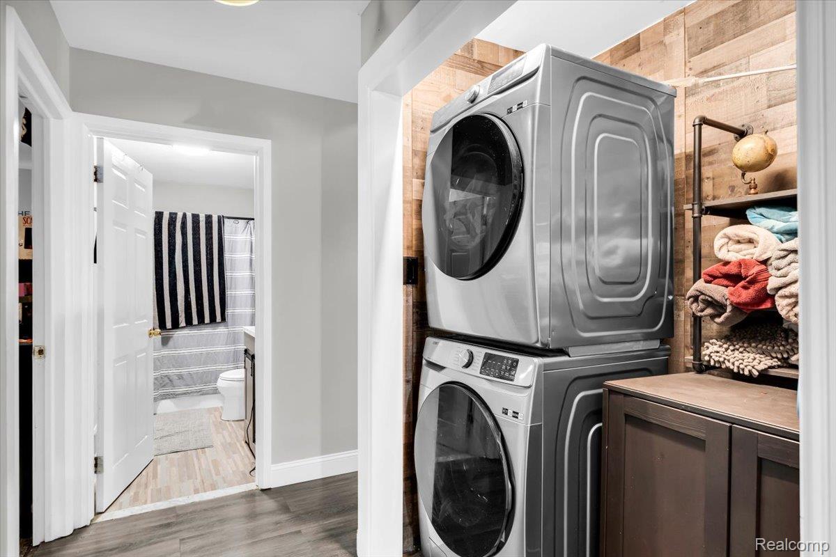 3260 Isabelle Street Inkster, MI 48141 - Photo 26 of 35 Dedicated laundry area featuring stacked appliances and wood-finish wall paneling