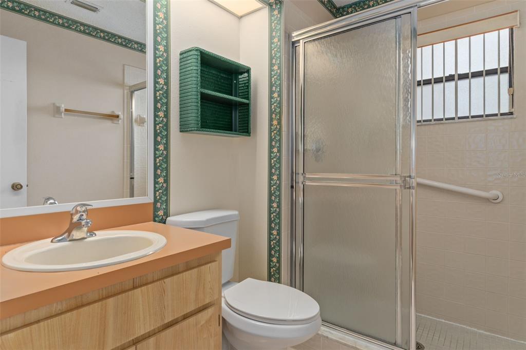 9474 Nakoma Way, Unit E Weeki Wachee, FL 34613 - Photo 19 of 31 a bathroom with a sink toilet and shower