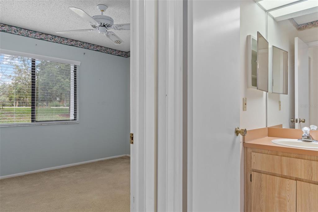 9474 Nakoma Way, Unit E Weeki Wachee, FL 34613 - Photo 21 of 31 a bathroom with a sink and a mirror