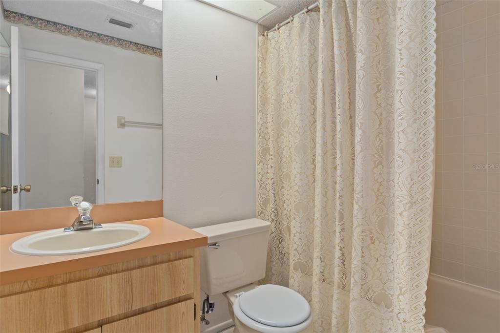 9474 Nakoma Way, Unit E Weeki Wachee, FL 34613 - Photo 22 of 31 a bathroom with a sink a toilet and shower
