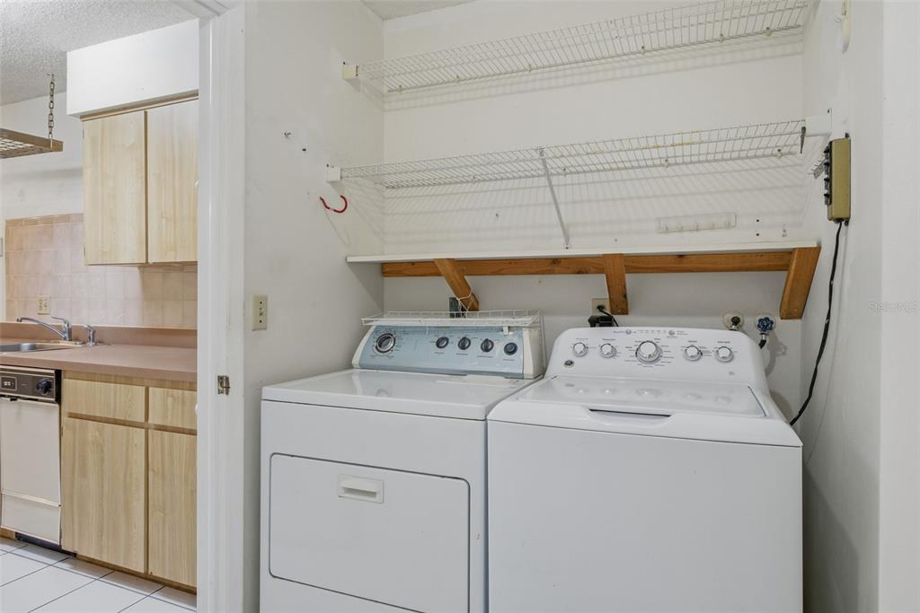 9474 Nakoma Way, Unit E Weeki Wachee, FL 34613 - Photo 27 of 31 a utility room with dryer and washer