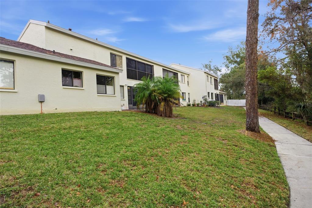 9474 Nakoma Way, Unit E Weeki Wachee, FL 34613 - Photo 31 of 31 a view of a house with backyard and garden