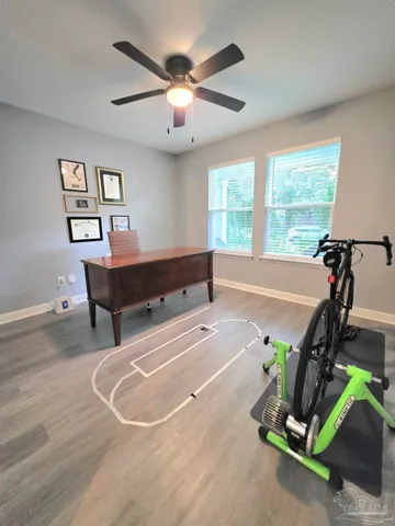 a room with gym equipment and windows