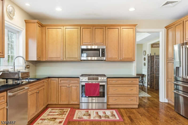 3 Marble Lane Randolph, NJ 07869 - Photo 14 of 46 a kitchen with stainless steel appliances wooden cabinets and a stove top oven