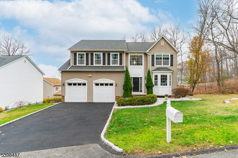3 Marble Lane Randolph, NJ 07869 - Photo 2 of 46 a front view of a house with a yard and garage