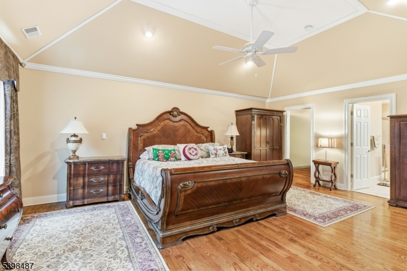 3 Marble Lane Randolph, NJ 07869 - Photo 30 of 46 a bedroom with a bed and a chandelier