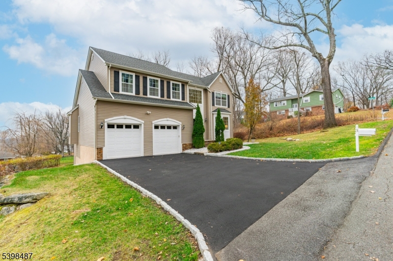 3 Marble Lane Randolph, NJ 07869 - Photo 4 of 46 a front view of a house with a yard and garage