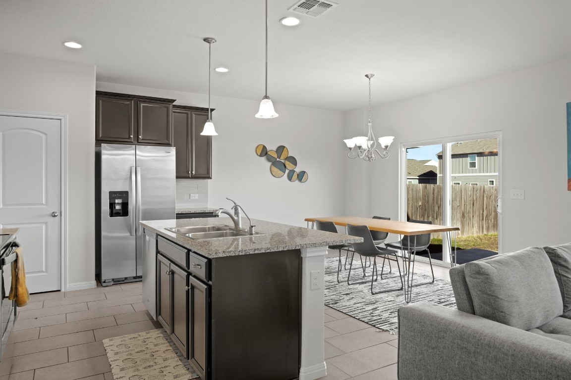 13005 Foreston Drive Austin, TX 78754 - Photo 36 of 36 a kitchen with stainless steel appliances granite countertop a sink a stove and a refrigerator