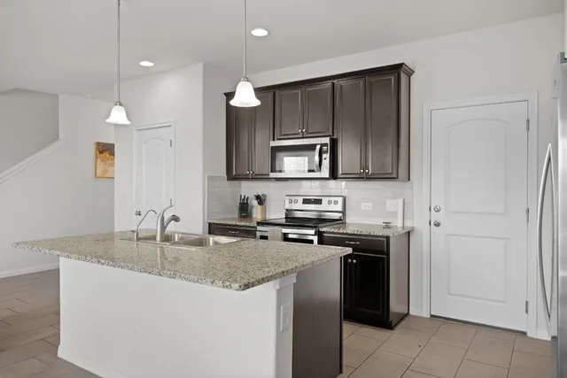 a living room with furniture a flat screen tv and a window