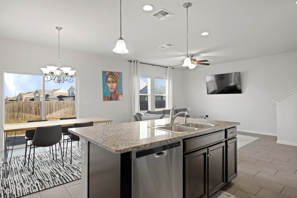 13005 Foreston Drive Austin, TX 78754 - Photo 18 of 36 a kitchen with a table chairs and a chandelier