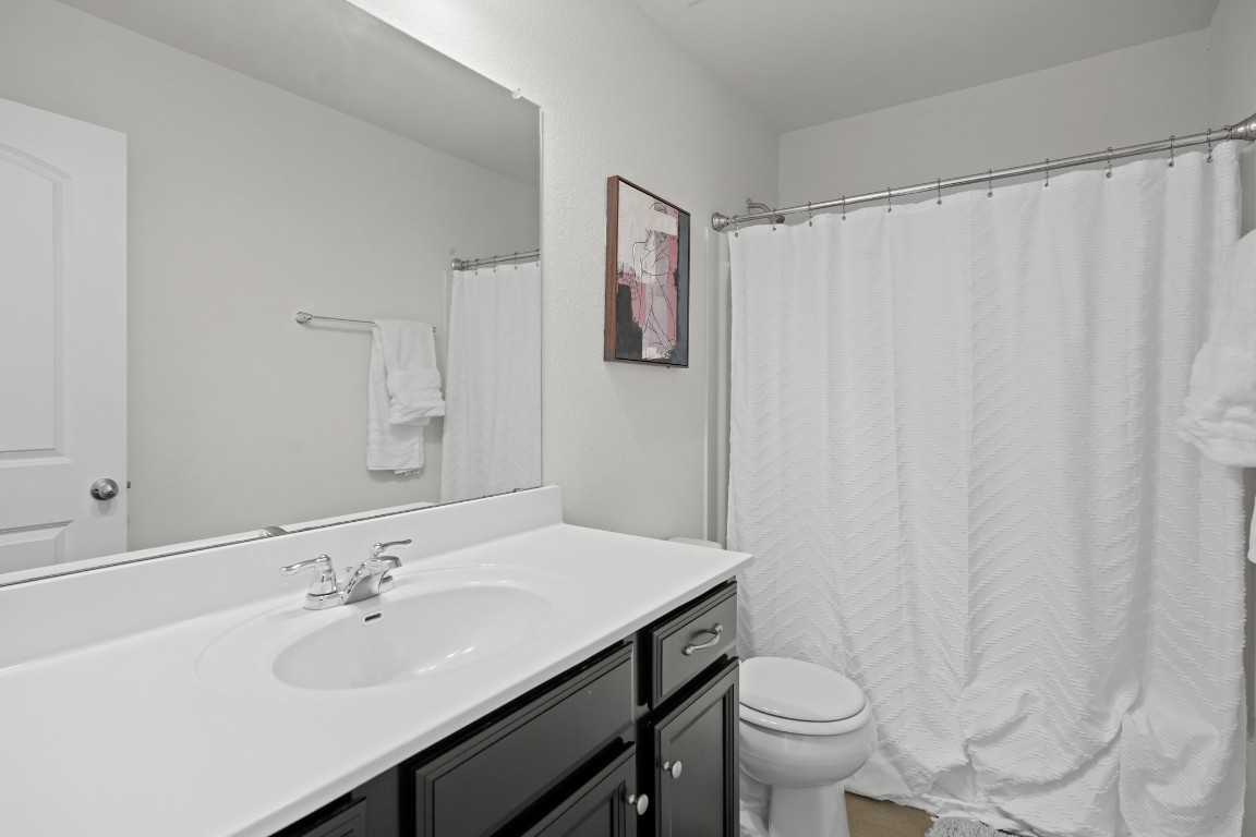 13005 Foreston Drive Austin, TX 78754 - Photo 24 of 36 a bathroom with a sink toilet and vanity