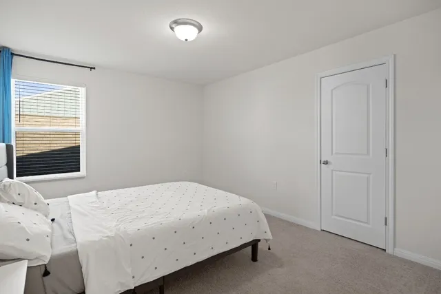 a bedroom with a bed and a view of room