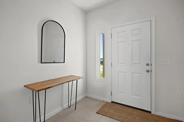 a view of front door with wooden floor