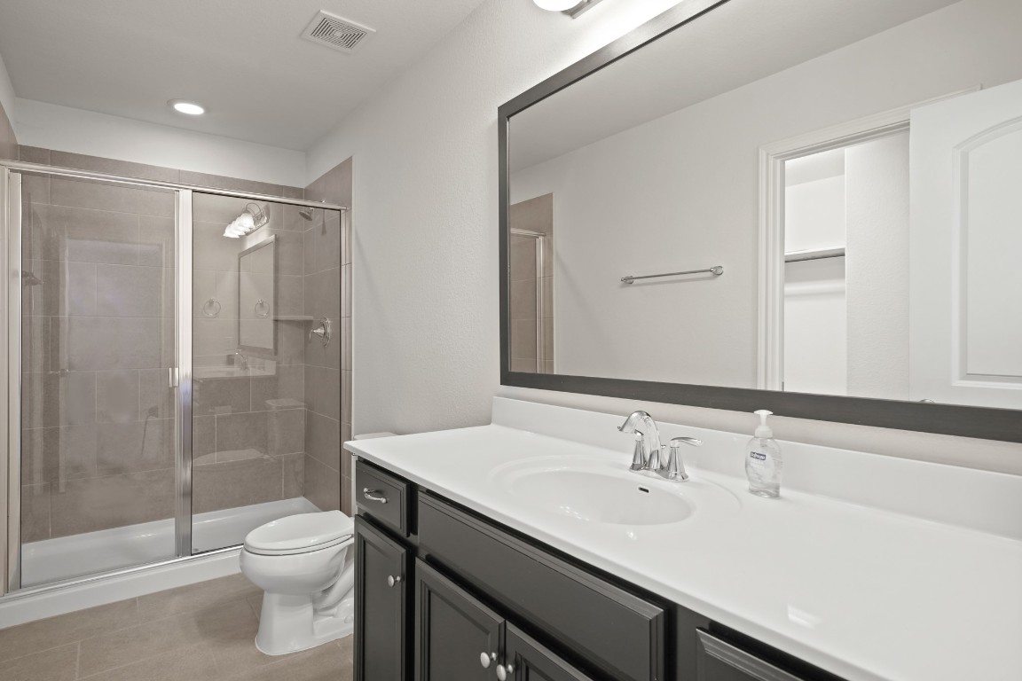 13005 Foreston Drive Austin, TX 78754 - Photo 30 of 36 a bathroom with a sink a toilet and shower