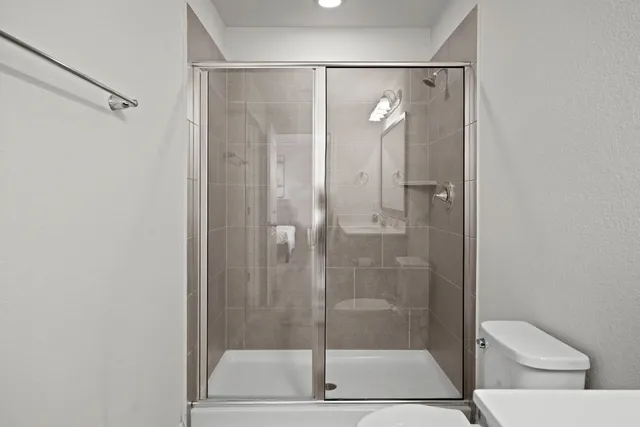 a bedroom with a bed and a ceiling fan