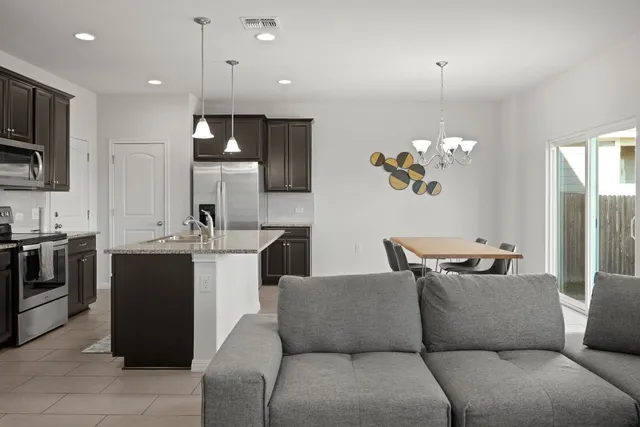 a view of field with grass and wooden fence