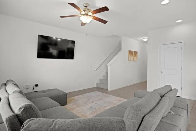 a living room with furniture and a large window