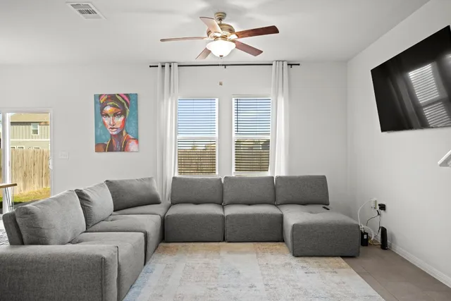a dining room with furniture a rug and wooden floor
