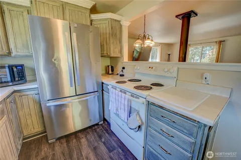 a kitchen with stainless steel appliances a refrigerator a sink a stove and cabinets