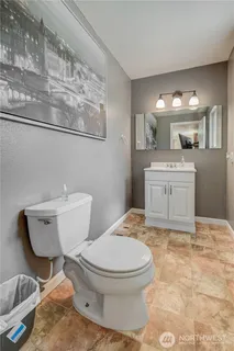 a bathroom with a toilet a sink and a mirror