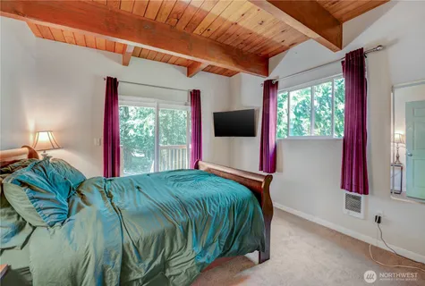 a bed sitting in a bedroom next to a window