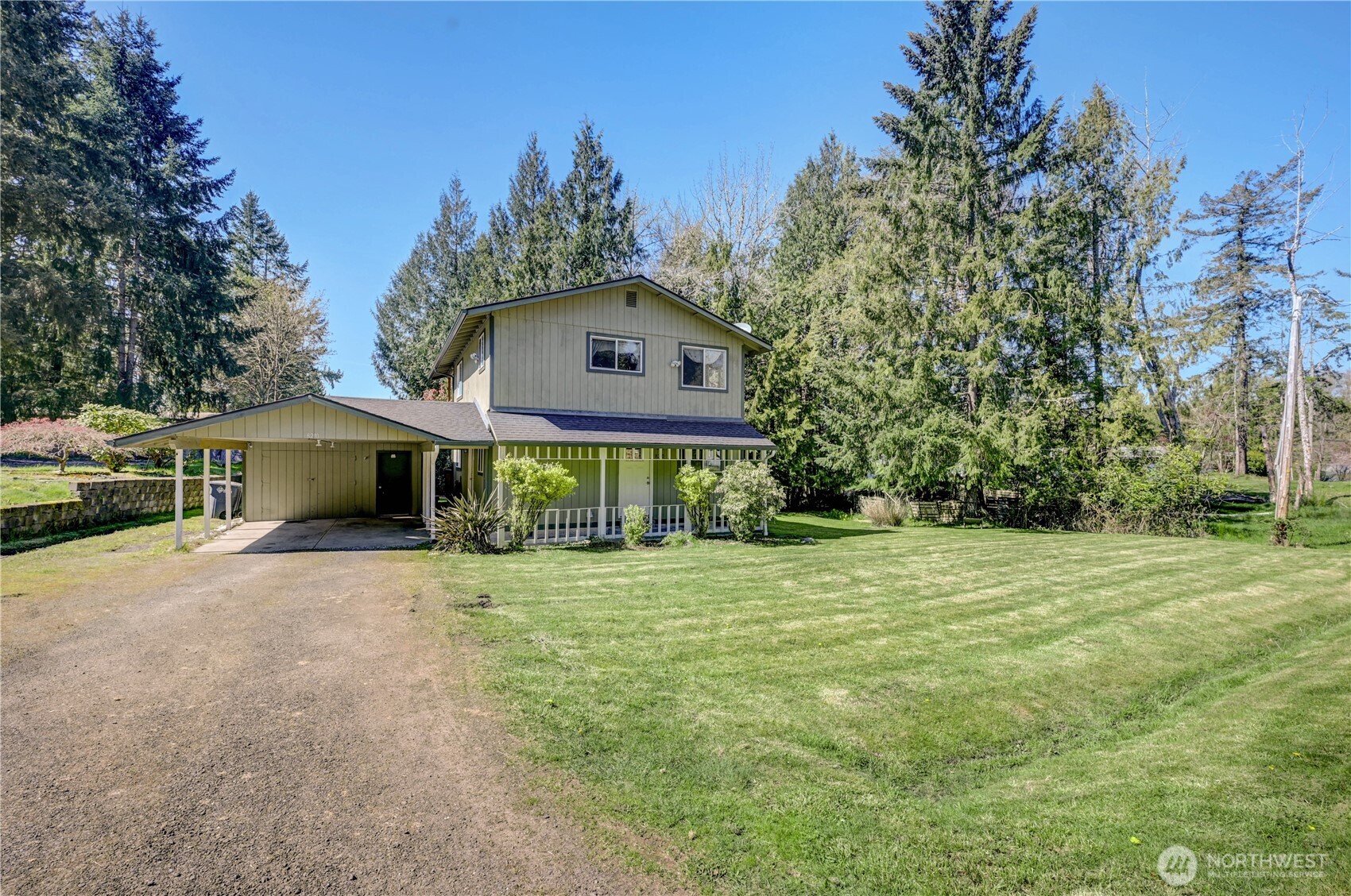 8210 176th Avenue Southwest Longbranch, WA 98351 - Photo 3 of 28 a front view of a house with a garden