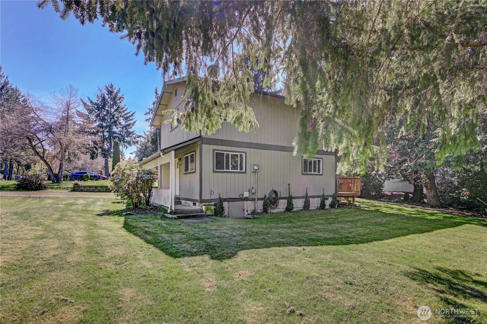 8210 176th Avenue Southwest Longbranch, WA 98351 - Photo 5 of 28 a front view of a house with a yard and trees