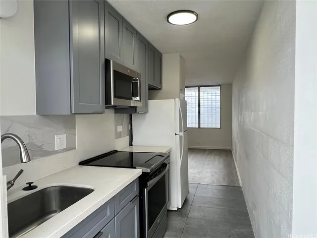 a kitchen that has a sink and a stove