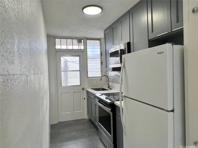 a kitchen with stainless steel appliances a refrigerator sink and cabinets