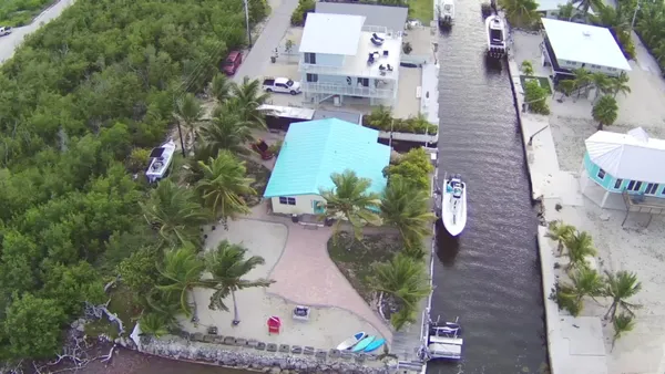 an aerial view of a house with a yard and garden
