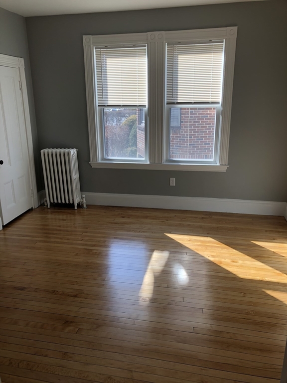 203 High Street Brookline, MA 02445 - Photo 12 of 18 a view of empty room with wooden floor and fan