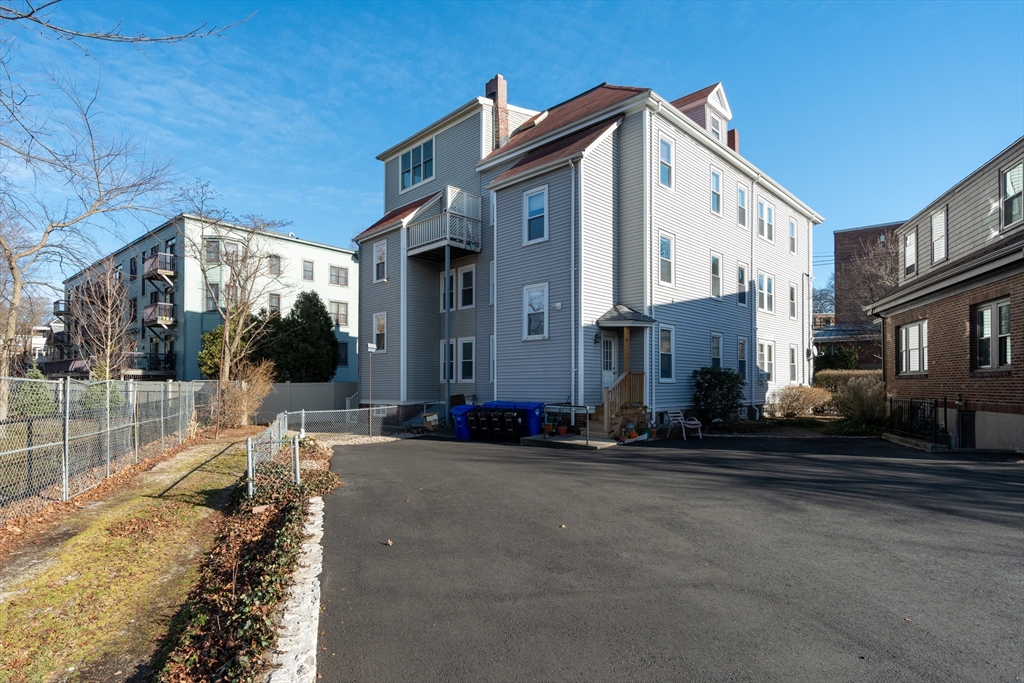 203 High Street Brookline, MA 02445 - Photo 16 of 18 a front view of a house with a yard