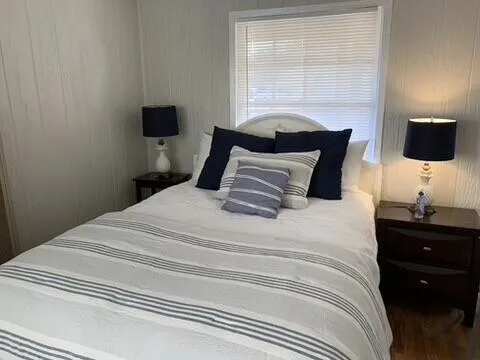 a bedroom with a bed and a window