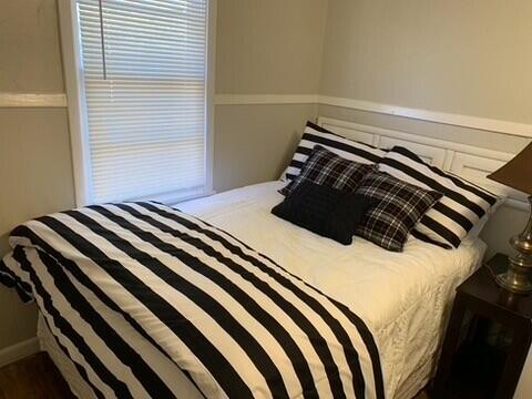 2323 25th Street, Unit REAR Lubbock, TX 79411 - Photo 6 of 8 a bedroom with a bed and a window