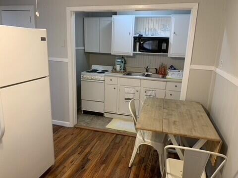 2323 25th Street, Unit REAR Lubbock, TX 79411 - Photo 7 of 8 a kitchen with a refrigerator and a stove top oven