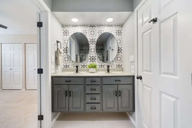 a bathroom with a double vanity sink and mirror